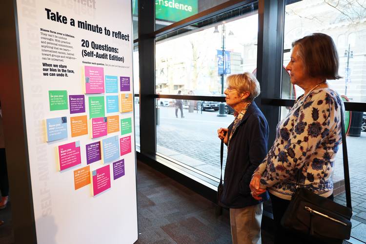 Interactive elements display how bias is reflected in product design, advertising, architecture and technology.